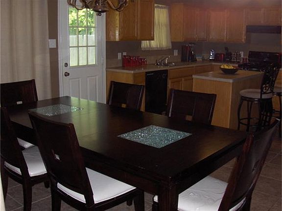 The dining area is open to the den and kitchen.
