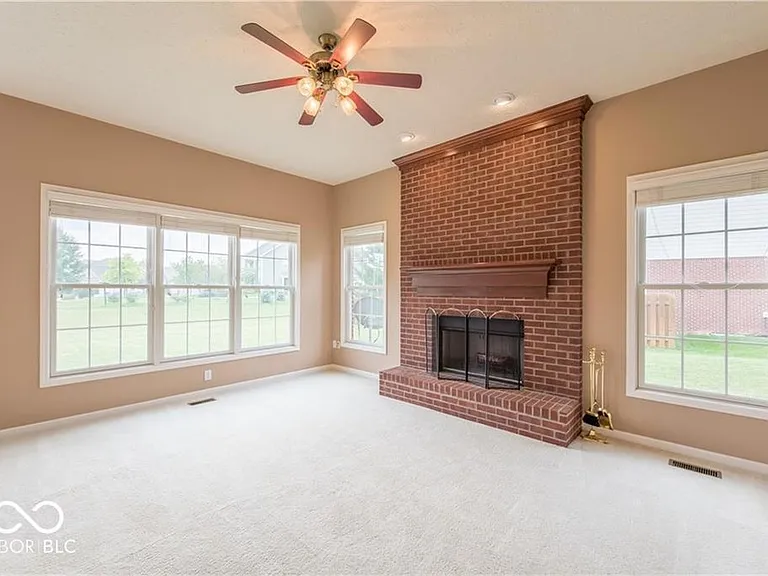 Family room, the brick fireplace has been painted