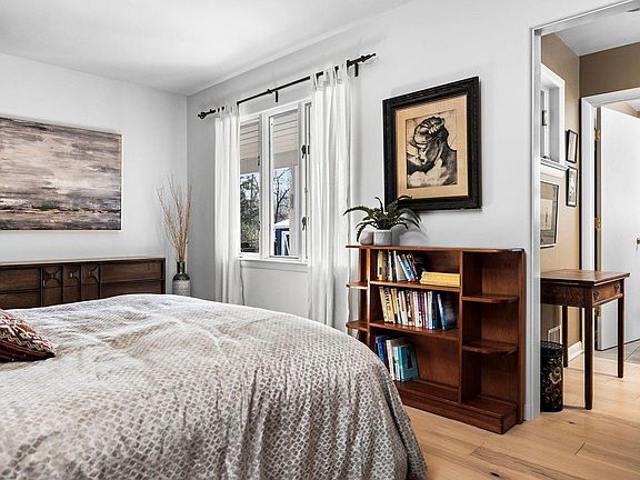 Master bedroom with picture window overlooking patio