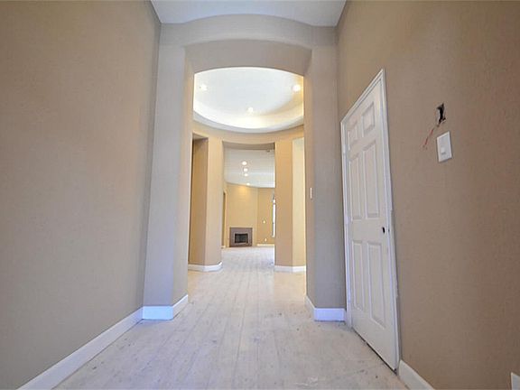 Amazing Entry with High almost 2 Story High Ceilings, Rounded Corners, Recessed Lighting and Upgraded Tile that looks almost like Hardwood Floor but less Upkeep, simply stunning.
