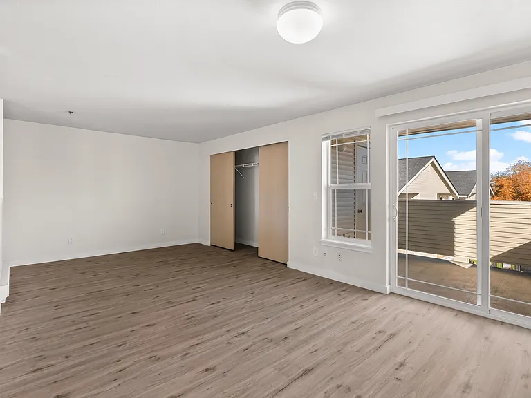 Bright, open bedroom with balcony access and ample closet space. Bright, open bedroom with balcony access and ample closet space.