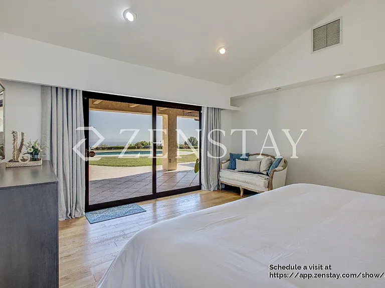 pacious primary bedroom with king bed and serene ambiance