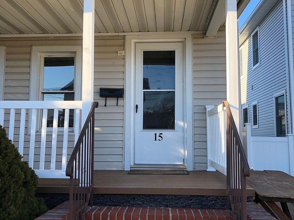 Brick steps and railing lead to huge front porch and entrance to your new home
