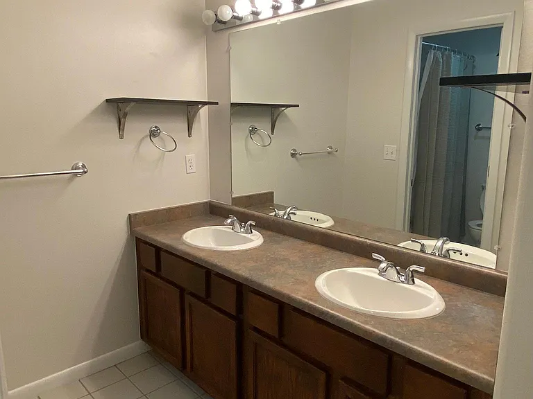 Second full bathroom with double sinks and ample storage