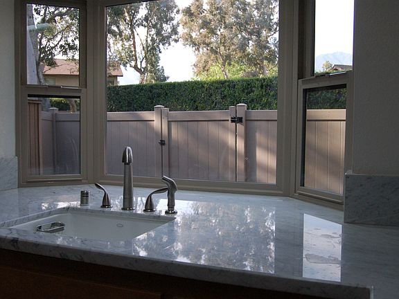 newer vinyl fence in back