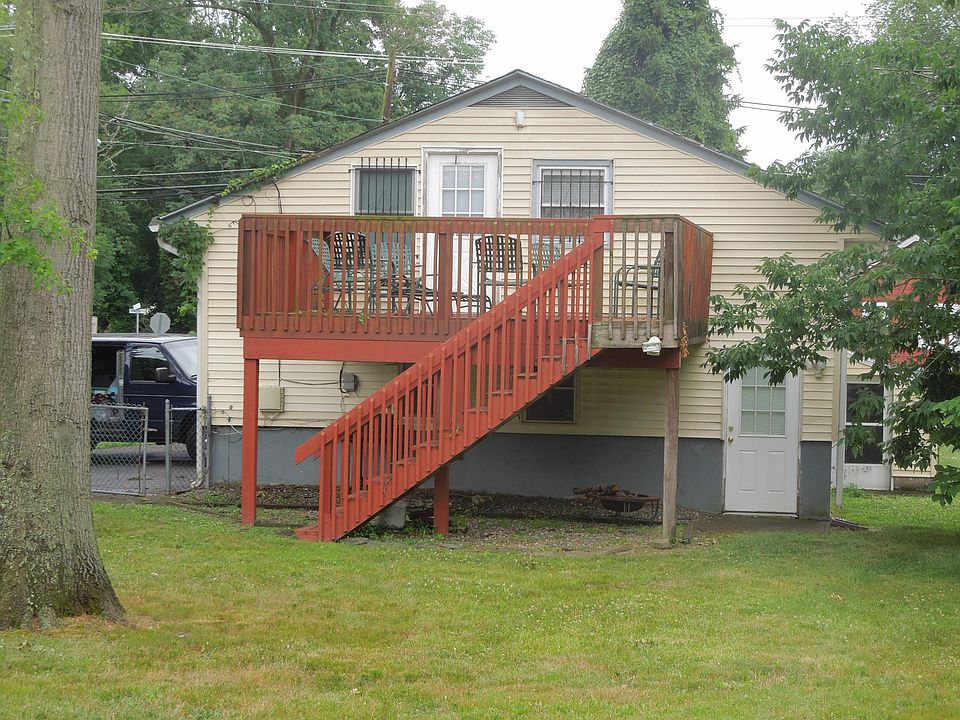 Side entrance with deck and large backyard.