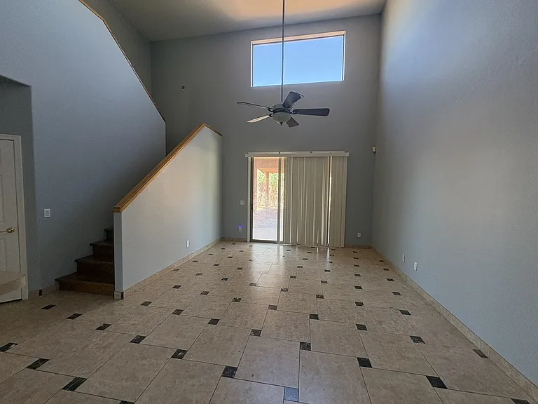Looking into the den and the stairs to go to all the bedrooms. You can also go out into the back yard. Lofted ceiling and large sun window.