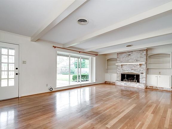 Large family room with views of the backyard, fireplace, and nice built-ins.