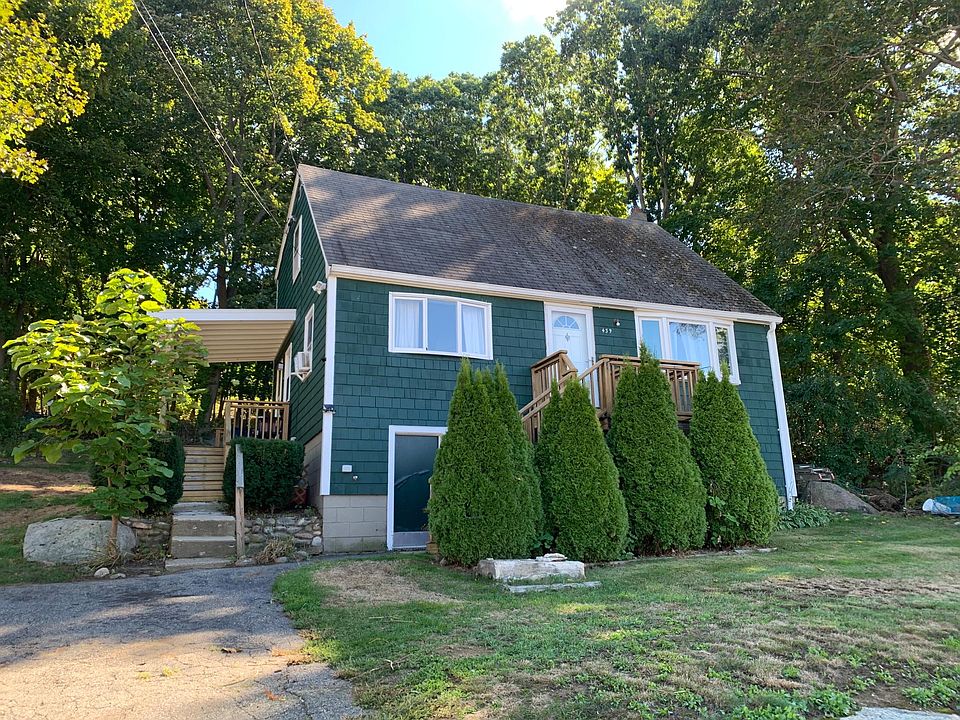 Front Yard view, left staircase leads to covered porch and kitchen entrance. Small deck and stairs off front of house!