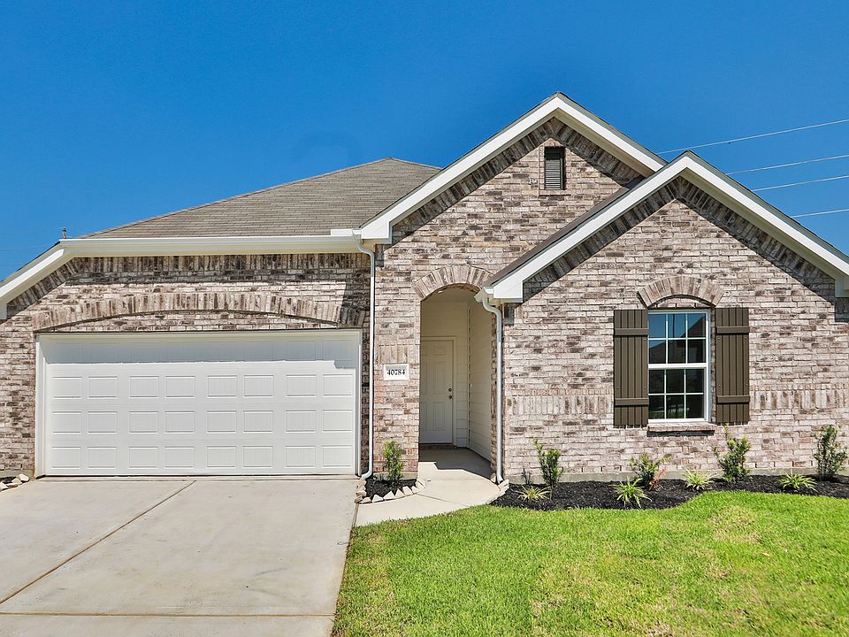 Elegant brick facade with arched entryway in Mostyn Springs, Magnolia, TX.
