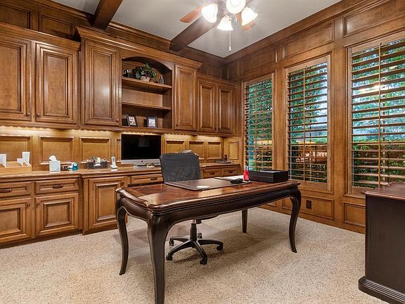 The classic wood paneled study provides the perfect space to get some serious work done. These stunning built in cabinets with recessed lighting offer so much organization space you will want to work from home everyday.