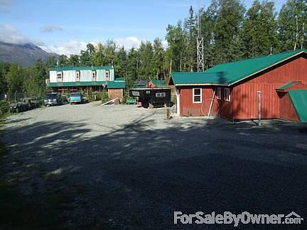 looking down driveway at shop and house