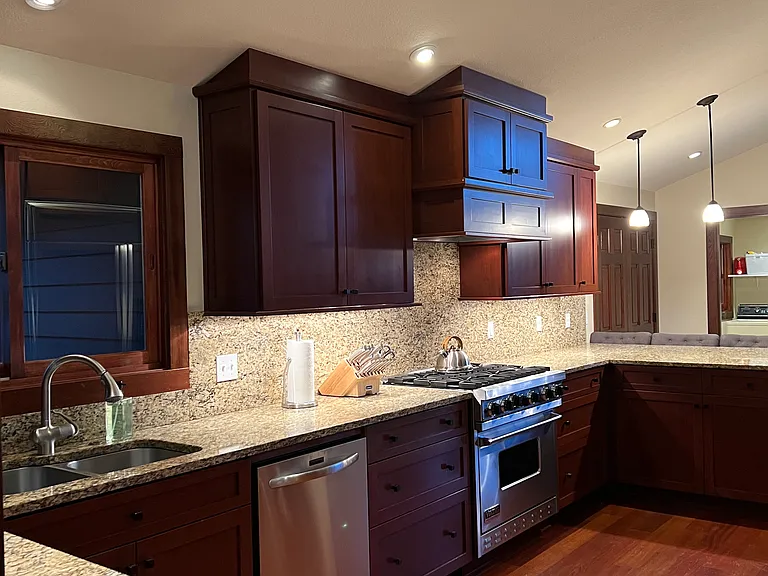 Custom cabinets and site finished cherry floors. Viking 6 burner convection stove, separate Dacor convection electric oven. Dacor convection microwave. Lots of built ins!!
