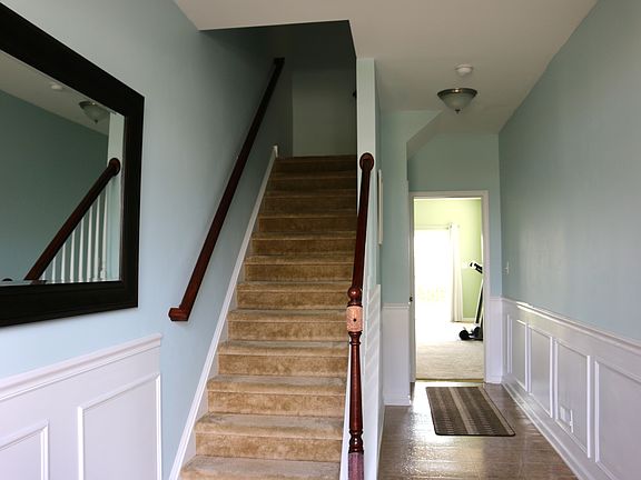Welcoming Foyer Finished With Wainscoting