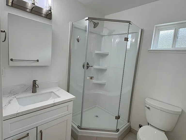 Bathroom and shower. Vanity mirror includes a medicine cabinet