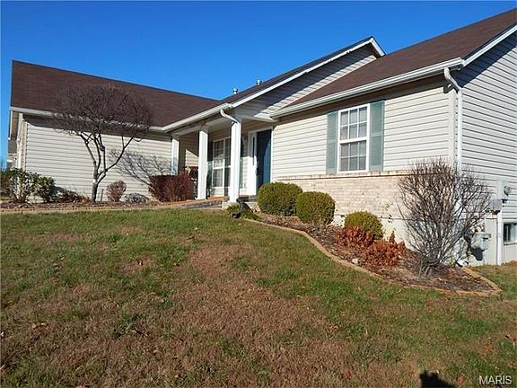 Side view of home showing landscaping.