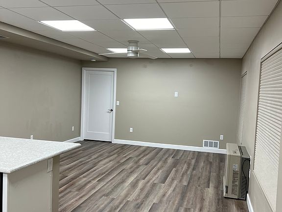 Living room with mountain views, LVP flooring throughout and ceiling fan.