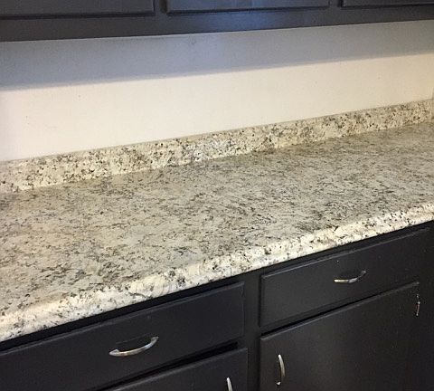 Lovely new counters with freshly painted dark gray cabinetry