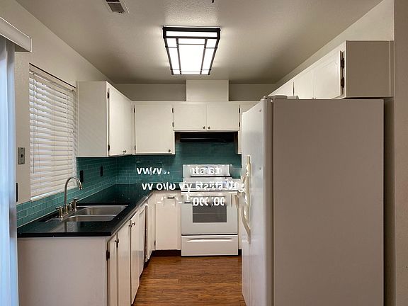 Kitchen includes oven/stove, dishwasher, and fridge.