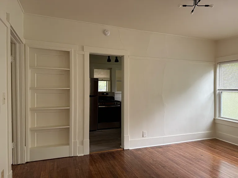 Bookshelf next to kitchen entry.