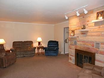Spacious living room with gas burning brick fireplace