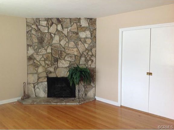 The river rock fireplace provides a focal point for the living r