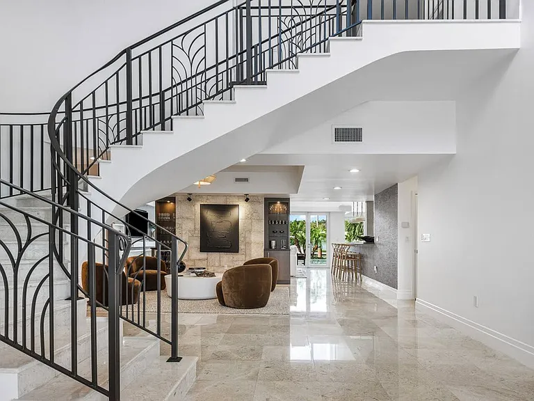 Elegant staircase leading to the upper level, showcasing refined architectural details.
