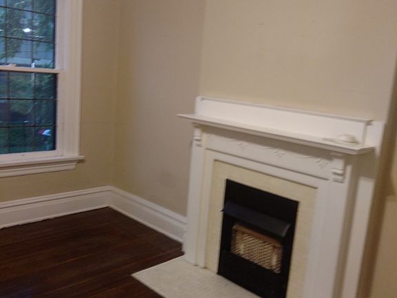 Charming bedroom with decorative fireplace.