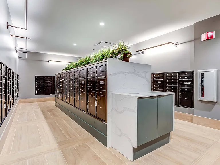 Easily manage your deliveries in the convenient mailroom, designed to keep your packages and mail organized and accessible.