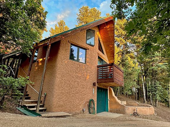 Northwestern facade showing covered stairway and garage door.