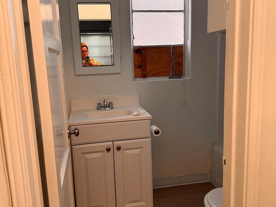 bathroom has storage above the commode and below the sink...tiled shower/tub combination has handheld shower.