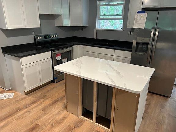 Kitchen. New stove and refrigerator. Dishwasher in island.