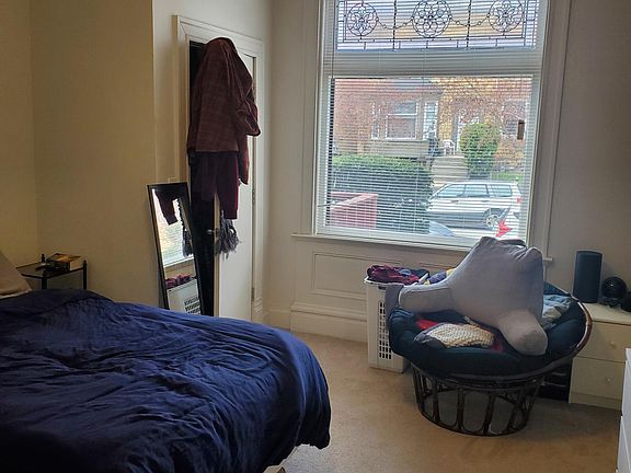Carpeted bedroom with lots of natural light