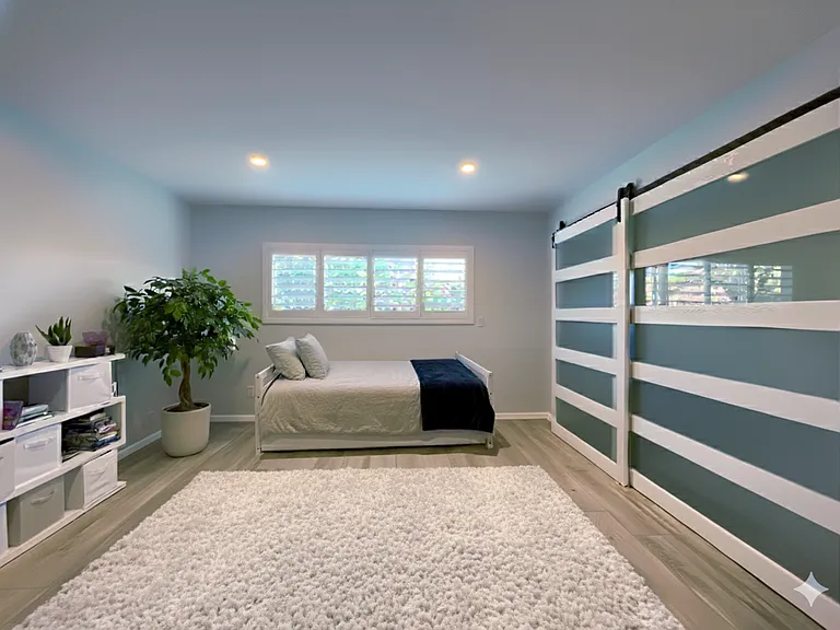This spacious secondary bedroom is currently set up as a kids' room but can easily serve as a guest suite or home office.