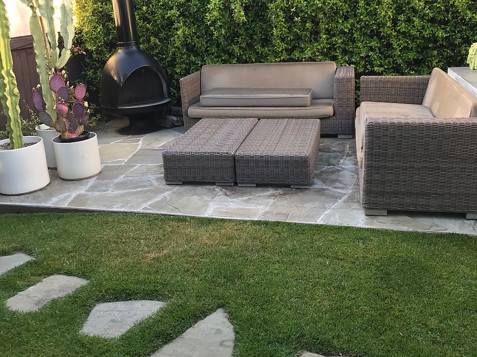 Large yard with faux grass and large flagstone area great for lounge chairs and sofa