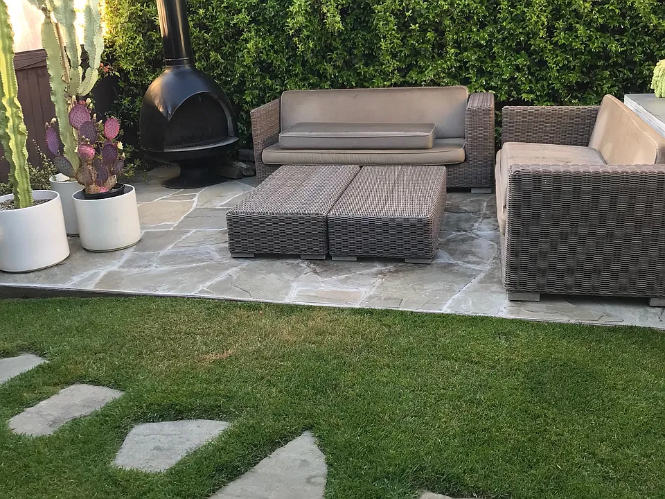 Large yard with faux grass and large flagstone area great for lounge chairs and sofa