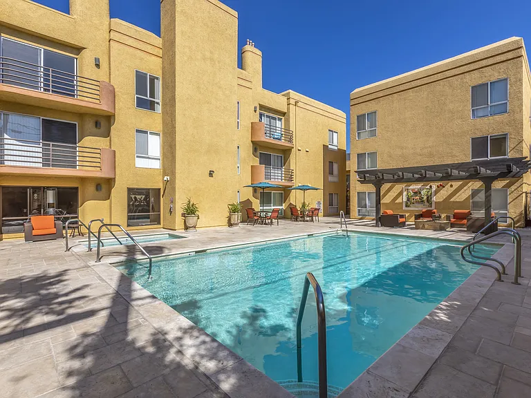 Apartments in Burbank, CA - Pool and Patio with Lounge Chairs, Tables and Umbrellas