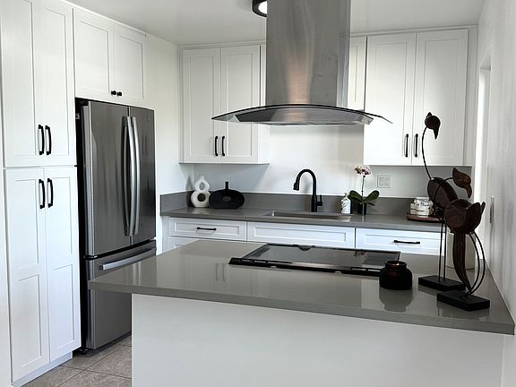 This elegantly renovated kitchen boasts brand new countertops, cabinets, and stainless steel appliances.