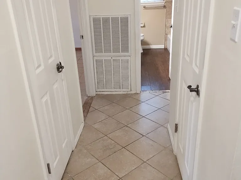 From Entryway looking into hallway with Front Bathroom shown in distance.