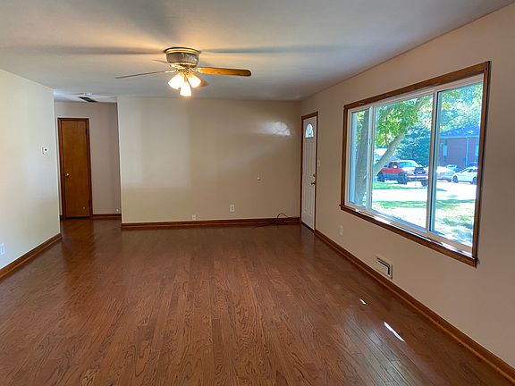 Ceiling fan and large picture window in Living area