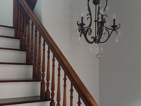 Stairwell has a chandelier too