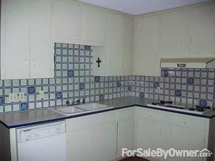 Kitchen : There is a bar with stools on the other side of the kitchen.