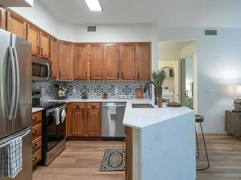 Open Kitchen with Island Seating and Wood Cabinetry