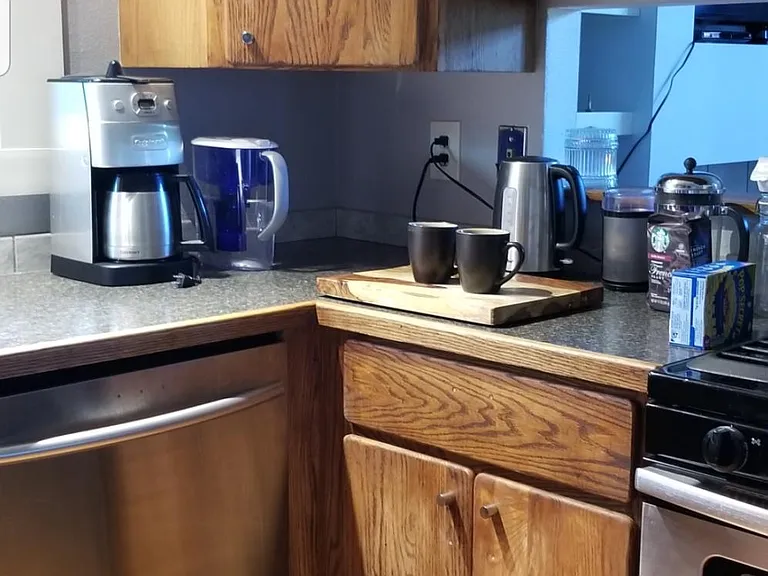 view showing coffee area and pass-through window into the living room. Easy to maintain conversations while cooking.