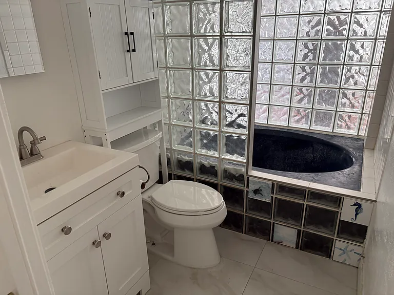 Renovated Bathroom with new tile and Original Huge Blue Tub