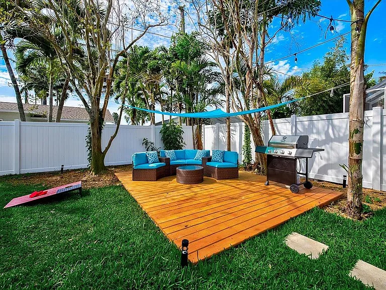 Beautiful backyard Patio Furniture and lawn games! Brand new half moon sofa seats six. New grill included.