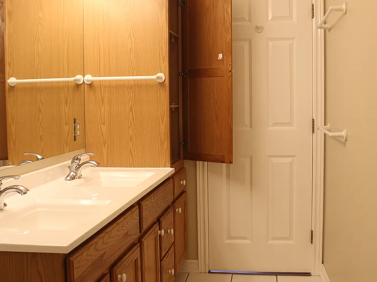 Master bathroom with double sinks and linen closet