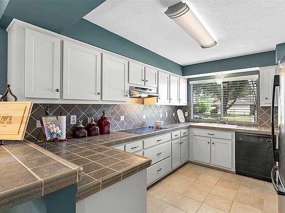 Spacious kitchen with good counter space, 2 pantries, electric cook top, refaced cabinets with added hardware and refrigerator stays.