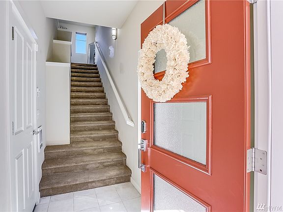 Tiled entrance provides a terrific space to remove the shoes so your carpets stay pristine!  Door to the left is the entrance to the spacious, two-car garage!