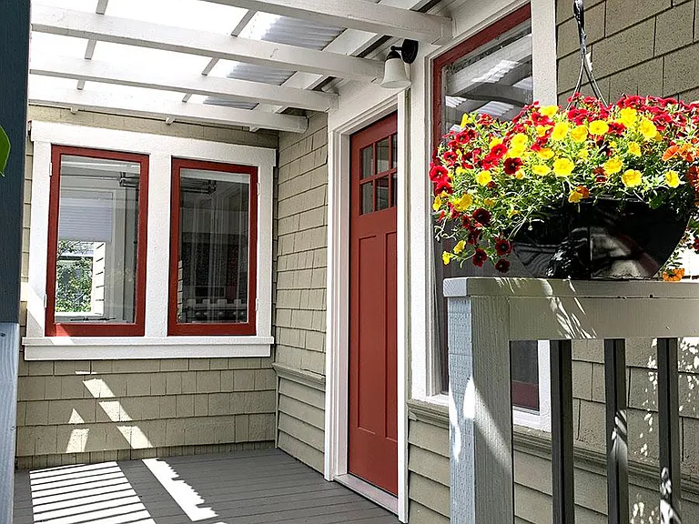 Private entrance with bright covered front porch, perfect for morning coffee.